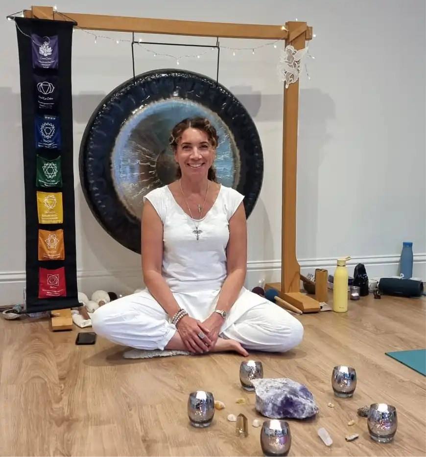 Sam in front of gong with cacao ceremony cups